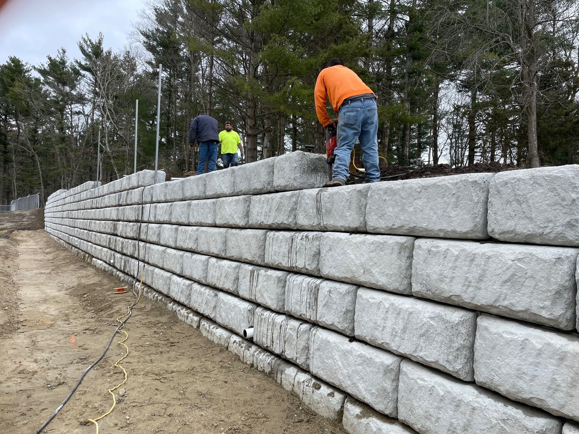 Installation of Posts Cored into Concrete Block Retaining Wall